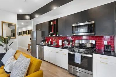a kitchen with white cabinets and a stove top oven at 4BR Duplex, Prime Location in Newark