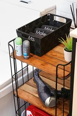 a shelf with three baskets on top of a table at 4BR Duplex, Prime Location in Newark