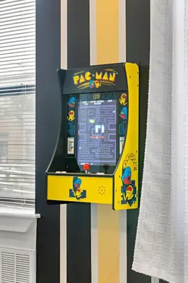 a pape war game machine on a wall at 4BR Duplex, Prime Location in Newark
