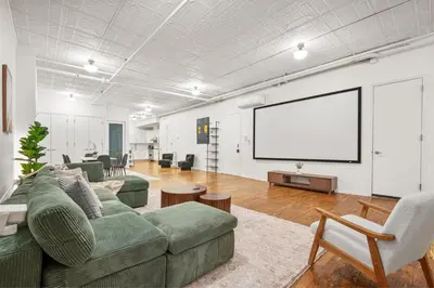 a living room with a couch and a white screen at Soho Fancy 4 Bedroom 2000 square feet Loft in New York
