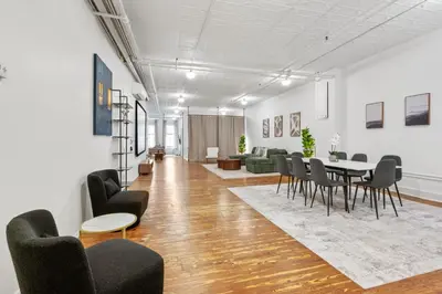a living room with a table and chairs at Soho Fancy 4 Bedroom 2000 square feet Loft in New York