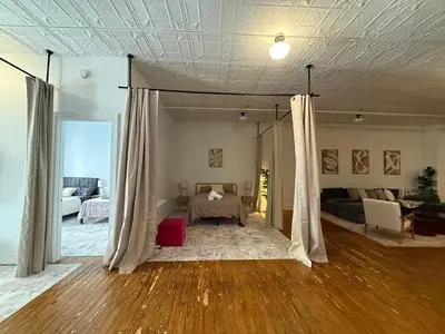 a bedroom with a bed and a living room at Soho Fancy 4 Bedroom 2000 square feet Loft in New York