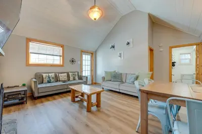 a living room with a couch and a table at The Cozy Cabin in Blakeslee