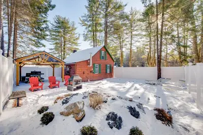 a log cabin in the snow in a yard at The Rustic Cabin in Blakeslee