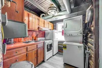 an rv kitchen with a stove and a refrigerator at The Rustic Cabin in Blakeslee