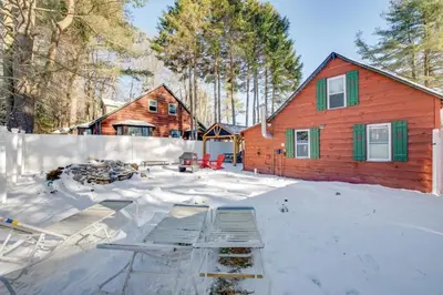 a house in the snow in front of a house at The Rustic Cabin in Blakeslee
