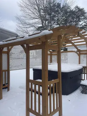 a wooden gazebo with snow on top of it at The Babbling Brooke in Blakeslee