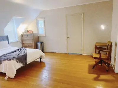 a bedroom with a bed and a desk and a chair at Lin Wood Retreat in Plainfield