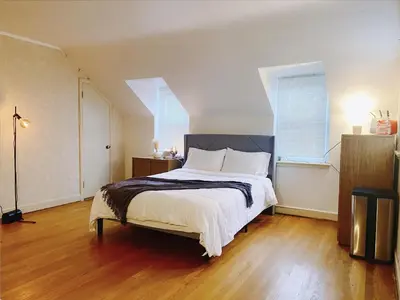 a bedroom with a large bed and two windows at Lin Wood Retreat in Plainfield