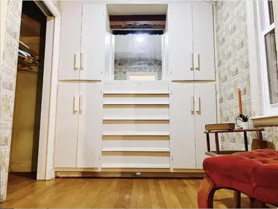 a white cabinet with a window in a room at Lin Wood Retreat in Plainfield