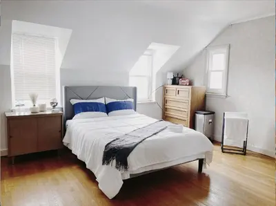 a bedroom with a large bed with blue pillows at Lin Wood Retreat in Plainfield