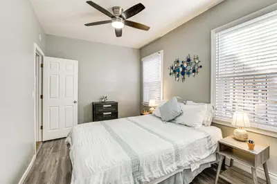 a bedroom with a bed and a ceiling fan at 1 Mi to Downtown Newark Urban Escape! in Newark