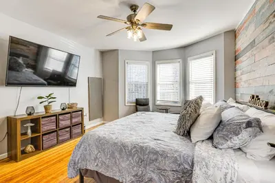 a bedroom with a bed and a ceiling fan at 1 Mi to Downtown Newark Urban Escape! in Newark