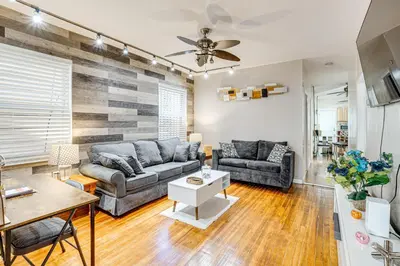 a living room with a couch and a table at 1 Mi to Downtown Newark Urban Escape! in Newark