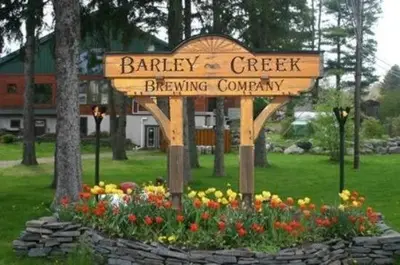 a sign for bakery creek drinking company in a garden at Ski Camelback Mountain in Tannersville