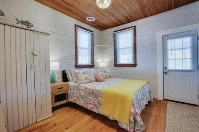 a bedroom with a bed and a wooden ceiling at Heart's Desire, a Cottage With Stunning Lake Views in Effort