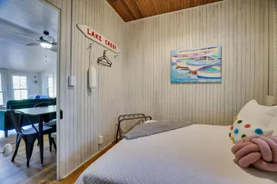 a bedroom with a bed and a dining room at Heart's Desire, a Cottage With Stunning Lake Views in Effort