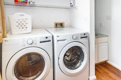 a laundry room with a washer and dryer at Spacious 3BR House, Hot Tub, Firepit, Ski Access! in Emerald Lakes