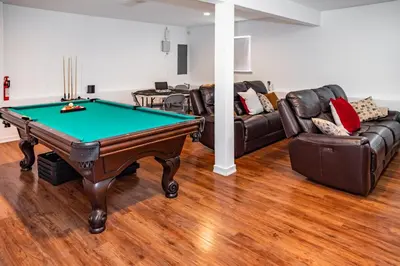 a living room with a pool table and couches at Spacious 3BR House, Hot Tub, Firepit, Ski Access! in Emerald Lakes