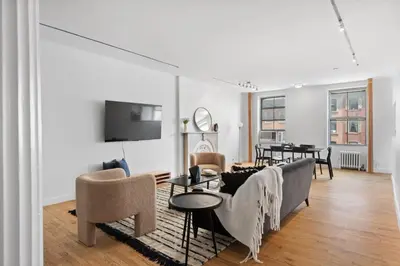 a living room with a couch and a table at Chelsea Canvas III by Rove Travel Charming 2BR Gem in New York