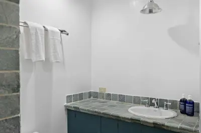 a bathroom with a sink and towels on a counter at Chelsea Canvas III by Rove Travel Charming 2BR Gem in New York
