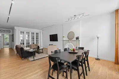 a dining room and living room with a table and chairs at Chelsea Canvas III by Rove Travel Charming 2BR Gem in New York