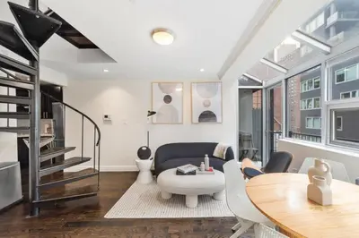 a living room with a table and a couch at Chelsea Vista II by Rove Travel 2BR PH with Rooftop in New York