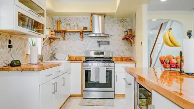 a kitchen with white cabinets and a stove at Home Away From Home in Philadelphia