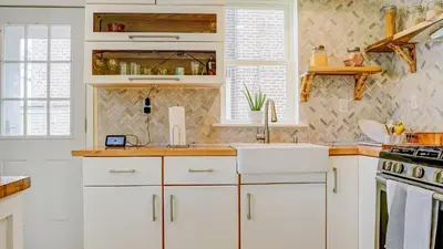 a kitchen with white cabinets and a sink at Home Away From Home in Philadelphia