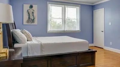 a blue bedroom with a bed and a window at Home Away From Home in Philadelphia