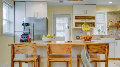 a kitchen with a counter with chairs and a refrigerator at Home Away From Home in Philadelphia