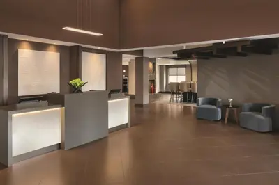 a lobby with a waiting area with chairs and tables at Hyatt Place Philadelphia/ King of Prussia in King of Prussia