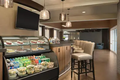 a restaurant with a bar with a bar stool at Hyatt Place Philadelphia/ King of Prussia in King of Prussia