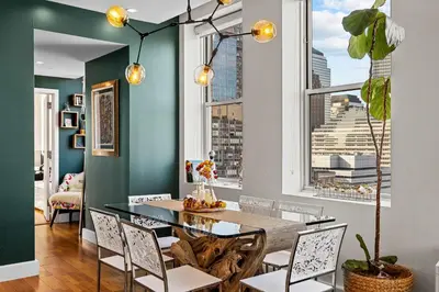 a dining room with a table and chairs at Broadway Terrace by Rove Loft with Private Terrace in New York