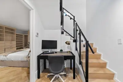 a room with a desk with a computer and a bed at Clinton by Rove Travel 3BR Duplex with Backyard in New York