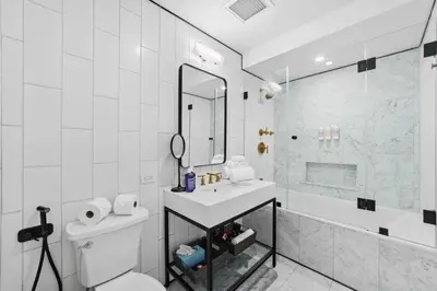a bathroom with a sink and a shower and a toilet at Clinton by Rove Travel 3BR Duplex with Backyard in New York