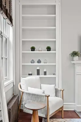 a living room with a chair and a table at Downing by Rove Travel Private Terrace & Patio in New York