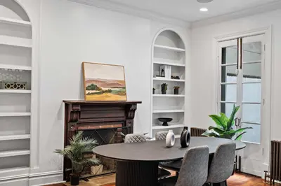 a living room with a table and a fireplace at Downing by Rove Travel Private Terrace & Patio in New York