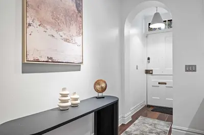 a hallway with a table with a sculpture on it at Downing by Rove Travel Private Terrace & Patio in New York