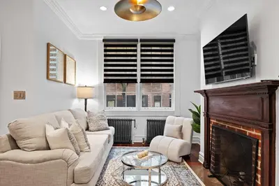 a living room with a couch and a fireplace at Downing by Rove Travel Private Terrace & Patio in New York
