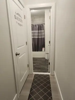 a hallway with a door leading to a bathroom at Comfy, cozy, affordable and private - free parking in Richmond Valley
