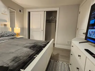 a bedroom with a bed and a desk with a computer at Comfy, cozy, affordable and private - free parking in Richmond Valley