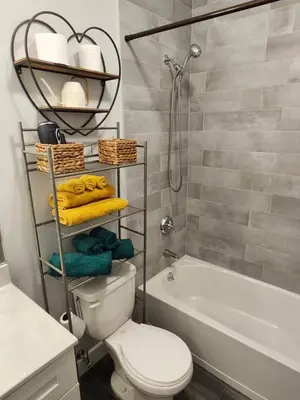 a bathroom with a toilet and a tub and a sink at Comfy, cozy, affordable and private - free parking in Richmond Valley