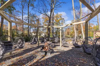 a playground with a fire pit and swings at New Luxury Lakeview Haven with Lake Access, HotTub, Game Room, Sleeps 26 in Lake Harmony