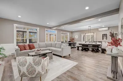 a living room with a couch and a table at New Luxury Lakeview Haven with Lake Access, HotTub, Game Room, Sleeps 26 in Lake Harmony