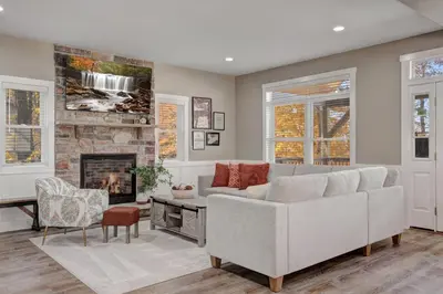 a living room with a couch and a fireplace at New Luxury Lakeview Haven with Lake Access, HotTub, Game Room, Sleeps 26 in Lake Harmony