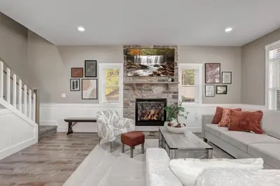 a living room with a couch and a fireplace at New Luxury Lakeview Haven with Lake Access, HotTub, Game Room, Sleeps 26 in Lake Harmony