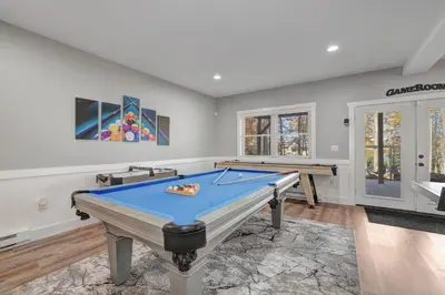 a game room with a pool table at New Luxury Lakeview Haven with Lake Access, HotTub, Game Room, Sleeps 26 in Lake Harmony