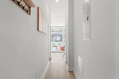 a hallway with white walls and wood floors and a hallway with white walls at Modern 1BR Apartment Downtown Philly Near MET in Philadelphia