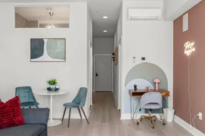 a living room with a couch and a table and chairs at Modern 1BR Apartment Downtown Philly Near MET in Philadelphia